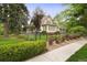 Lovely two-story home with well-maintained landscaping, a manicured lawn, and a classic black fence at 4535 E Montview Blvd, Denver, CO 80207