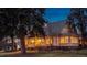 Elegant home exterior featuring a covered porch, balcony, and warm lighting at 4535 E Montview Blvd, Denver, CO 80207