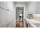 Hallway with hardwood floors, pantry, and marble countertops at 4535 E Montview Blvd, Denver, CO 80207