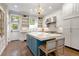 Bright kitchen with custom island, white cabinetry, and stainless steel appliances at 4535 E Montview Blvd, Denver, CO 80207