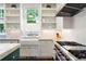 Well appointed kitchen with stainless steel appliances, open shelving, and a farmhouse sink at 4535 E Montview Blvd, Denver, CO 80207