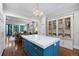 Spacious kitchen with blue island, open to living area, featuring modern appliances and hardwood floors at 4535 E Montview Blvd, Denver, CO 80207