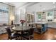 Eat-in kitchen with island, seating, and open to dining area with hardwood floors and natural light at 4535 E Montview Blvd, Denver, CO 80207