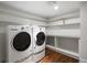 Functional laundry room with a washer, dryer, and plenty of shelving for organized storage at 4535 E Montview Blvd, Denver, CO 80207