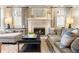 Relax in this living room with a fireplace, stylish furniture, and patterned curtains at 4535 E Montview Blvd, Denver, CO 80207