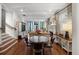 Open-concept living and dining area featuring hardwood floors and abundant natural light at 4535 E Montview Blvd, Denver, CO 80207