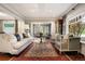 Spacious living area with large windows, plush seating, and hardwood floors at 4535 E Montview Blvd, Denver, CO 80207