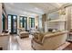 Bright living room with fireplace, plush seating, and French doors to outdoor space at 4535 E Montview Blvd, Denver, CO 80207