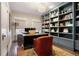 Office with a large desk, leather chairs, and built-in shelves at 4535 E Montview Blvd, Denver, CO 80207