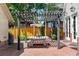 Charming outdoor patio area with a pergola, stone table, and brick flooring at 4535 E Montview Blvd, Denver, CO 80207