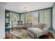 Bright sunroom with hardwood floors, shutters, and seating area at 4535 E Montview Blvd, Denver, CO 80207