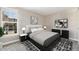 Modern bedroom with neutral tones, stylish decor, and a large window for ample natural light at 2179 Sunridge Cir, Broomfield, CO 80020