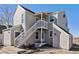 Charming exterior view of the two-story home with stairwell entrance to the upper floor at 2179 Sunridge Cir, Broomfield, CO 80020