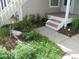 Lush front yard with an assortment of greenery and a small decorative garden at 2179 Sunridge Cir, Broomfield, CO 80020