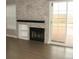 Bright living room with a cozy fireplace, hardwood floors, and access to a private deck with scenic views at 2179 Sunridge Cir, Broomfield, CO 80020