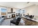 Cozy living room with a fireplace and large windows offering panoramic views and a dining area at 2179 Sunridge Cir, Broomfield, CO 80020