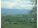 Sweeping vista of a valley and snow-capped mountain range in the distance at 2179 Sunridge Cir, Broomfield, CO 80020