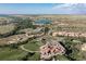 Aerial view of a community offering resort-style living with a golf course, lake, and rolling hills at 7952 Dante Dr, Littleton, CO 80125