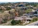 An elevated view showcasing an estate home nestled among red rocks and lush green landscape at 7952 Dante Dr, Littleton, CO 80125