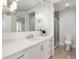 Bright bathroom features a modern vanity with stylish sconces, silver hardware, and glass shower at 7952 Dante Dr, Littleton, CO 80125