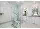 Modern bathroom showcasing a glass shower, double vanity, and bright natural light at 7952 Dante Dr, Littleton, CO 80125