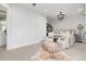 Relaxing bedroom boasts a patterned ottoman, carpet, and a doorway to an ensuite bathroom at 7952 Dante Dr, Littleton, CO 80125