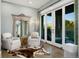 Cozy bedroom retreat boasting a decorative mirror, stylish chairs, and floor-to-ceiling sliding glass doors at 7952 Dante Dr, Littleton, CO 80125