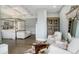 Beautiful bedroom featuring a four-poster bed, white sofa, hardwood floors, and a decorative cabinet at 7952 Dante Dr, Littleton, CO 80125