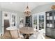 Bright dining room with a chandelier, round table, and doors to the outside at 7952 Dante Dr, Littleton, CO 80125
