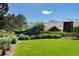 Welcome to Ravenna, featuring a modern sign, lush landscaping, and scenic mountain views at 7952 Dante Dr, Littleton, CO 80125