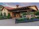 Elegant community entrance with stone details, a cozy fireplace, and manicured landscaping at 7952 Dante Dr, Littleton, CO 80125