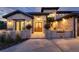 Stunning stone home exterior with a cozy outdoor seating area and beautiful arched doorway at 7952 Dante Dr, Littleton, CO 80125