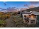 Aerial twilight view of the back of a multi-story home with mountain views at 7952 Dante Dr, Littleton, CO 80125