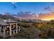 An exterior twilight view of a multi-story home with a backyard and mountain views at 7952 Dante Dr, Littleton, CO 80125