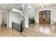Elegant foyer with hardwood floors, grand staircase, and a large wooden door at 7952 Dante Dr, Littleton, CO 80125