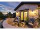 Charming stone courtyard featuring a fountain, seating area, and lovely landscaping at 7952 Dante Dr, Littleton, CO 80125