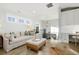 Comfortable living room space with sofa, ottoman, study nook, and staircase access at 7952 Dante Dr, Littleton, CO 80125