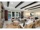 Bright living room boasts dark wood beam ceilings, patterned curtains, and plenty of comfy seating at 7952 Dante Dr, Littleton, CO 80125
