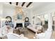 Elegant living room features stone fireplace, wooden beams and hardwood flooring at 7952 Dante Dr, Littleton, CO 80125