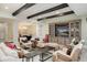 Spacious living room includes stylish entertainment center, modern light fixture and comfortable armchairs at 7952 Dante Dr, Littleton, CO 80125