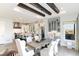 Open floor plan showcasing a dining area with wooden beams and a modern kitchen with stainless steel appliances at 7952 Dante Dr, Littleton, CO 80125