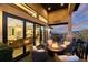 Stylish outdoor patio features a fire pit, wicker seating, and doors leading into the home's interior at 7952 Dante Dr, Littleton, CO 80125
