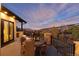 Scenic outdoor patio featuring comfortable seating, a dining table, and stunning views of the surrounding landscape at 7952 Dante Dr, Littleton, CO 80125
