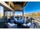 Luxury patio featuring a fire pit, comfortable seating, and panoramic views of the natural landscape at 7952 Dante Dr, Littleton, CO 80125