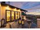 Cozy outdoor patio with wicker furniture, a gas fire pit, and scenic views during sunset at 7952 Dante Dr, Littleton, CO 80125