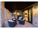 Outdoor patio features stone pillars, wood ceiling, and comfortable seating area with interior view at 7952 Dante Dr, Littleton, CO 80125