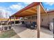 A covered patio with an outdoor seating area and built-in grill at 4713 Cody St, Wheat Ridge, CO 80033