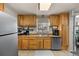 Functional kitchen featuring wood cabinets, stainless steel appliances, and tile floors at 4713 Cody St, Wheat Ridge, CO 80033