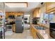 Well-lit kitchen featuring stainless steel appliances and tile flooring at 4713 Cody St, Wheat Ridge, CO 80033