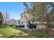 Large backyard with a well-maintained lawn and spacious patio featuring outdoor seating, a grill, and a tree at 19707 E 59Th Pl, Aurora, CO 80019